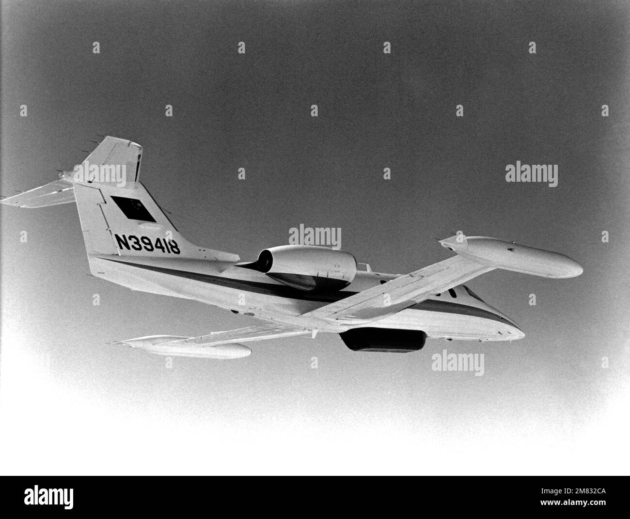 An air-to-air underside view of the first C-21A aircraft supplied to the People's Republic of China by Gates Learjet Aircraft Services Corporation, Wichita, Kansas. This aircraft is equipped with geological survey equipment. Country: Unknown Stock Photo