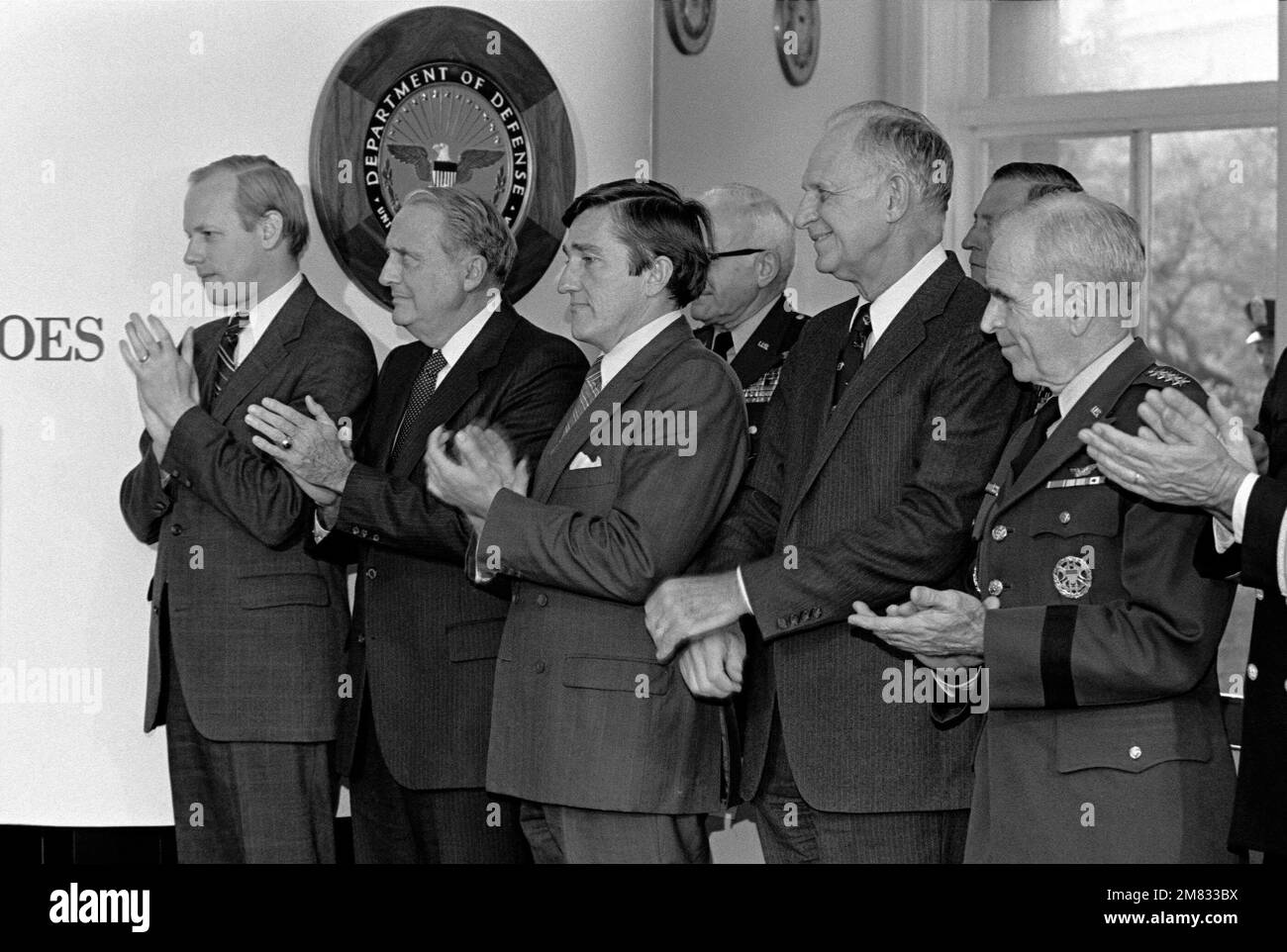 DD-SN-03-00653. [Complete] Scene Caption: Retiring Senator John Tower, Texas, Chairman Senate Armed Services Committee, receives awards from Secretary of Defense Caspar W. Weinberger, Secretary of the Services, John O. Marsh Jr., USA; John F. Lehman, USN, Verne Orr, USAF and MASTER CHIEF PETTY Officer, Navy, William H. Plackett assisted by Sergeant Major, Marine Command CHIEF MASTER Sergeant William B. Tapp Jr. Also in attendance were Defense Secretary William H. Taft IV, Joint Chiefs of STAFF; General John W. Vessey Jr., USA, Chairman, General John A. Wickham Jr., USA, Admiral James D. Watkin Stock Photo