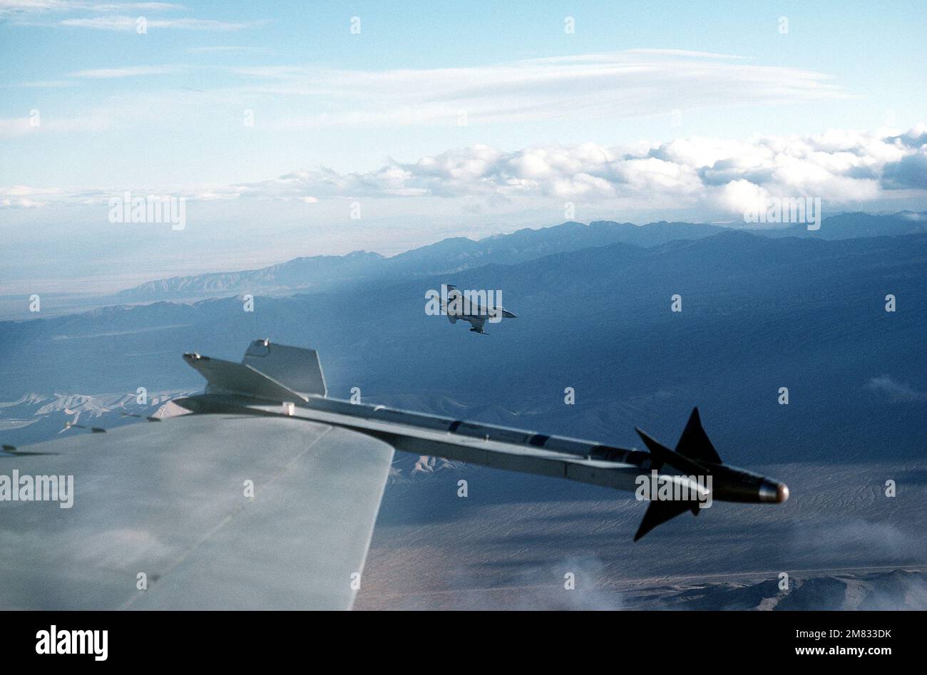 A close-up view of an AIM-9 Sidewinder missile on the wing of an F-16