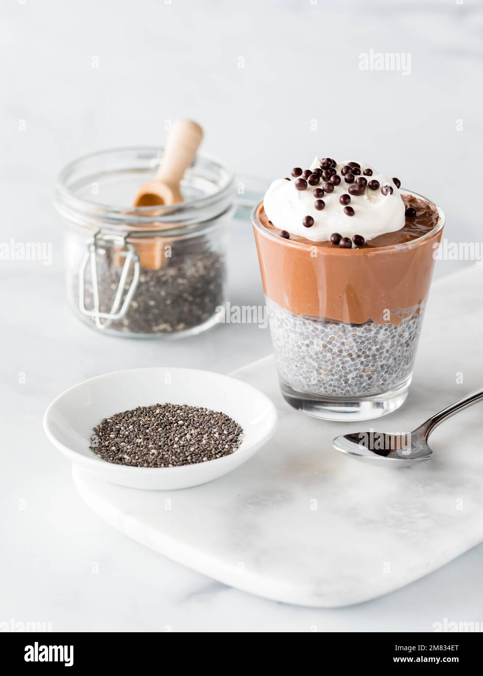 A chocolate mousse chia pudding snack with chia seeds to the side Stock