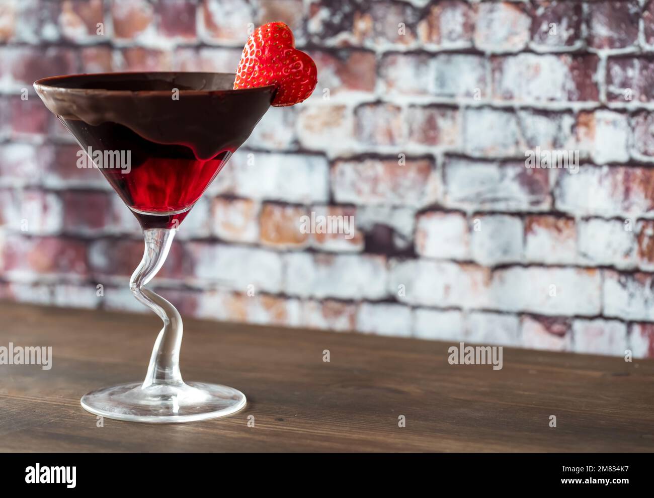 A Chocolate dipped Valentine's Day cocktail garnished with a heart strawberry. Stock Photo