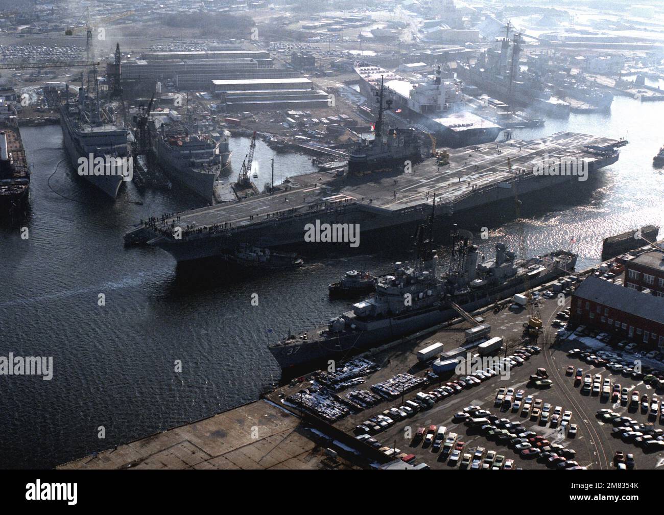 The guided missile destroyer USS FARRAGUT (DDG-37), foreground, stands ...