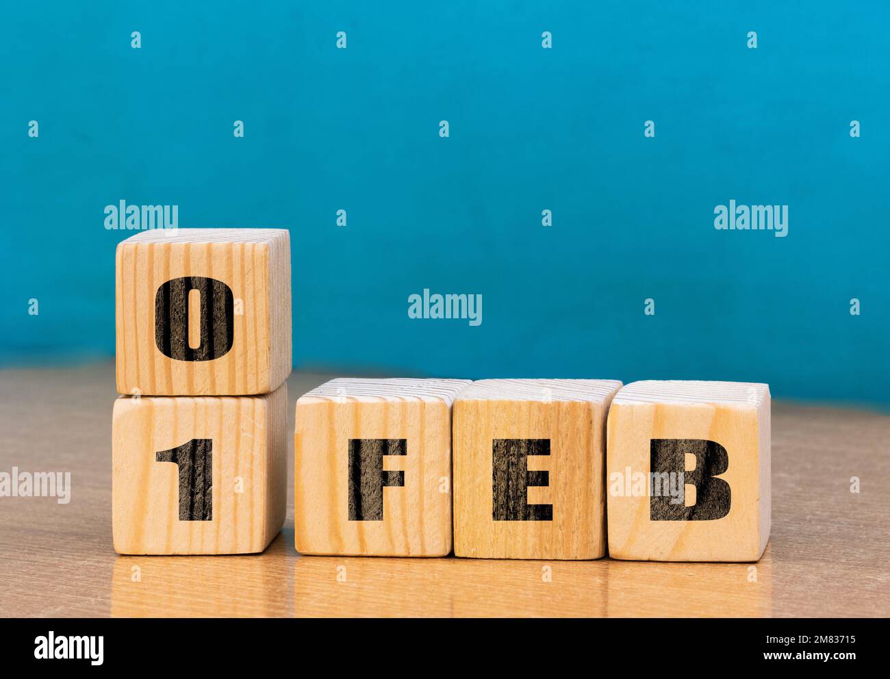 Cube shape calendar for February 01 on wooden surface with empty space for text,cube calendar for december on wood background Stock Photo