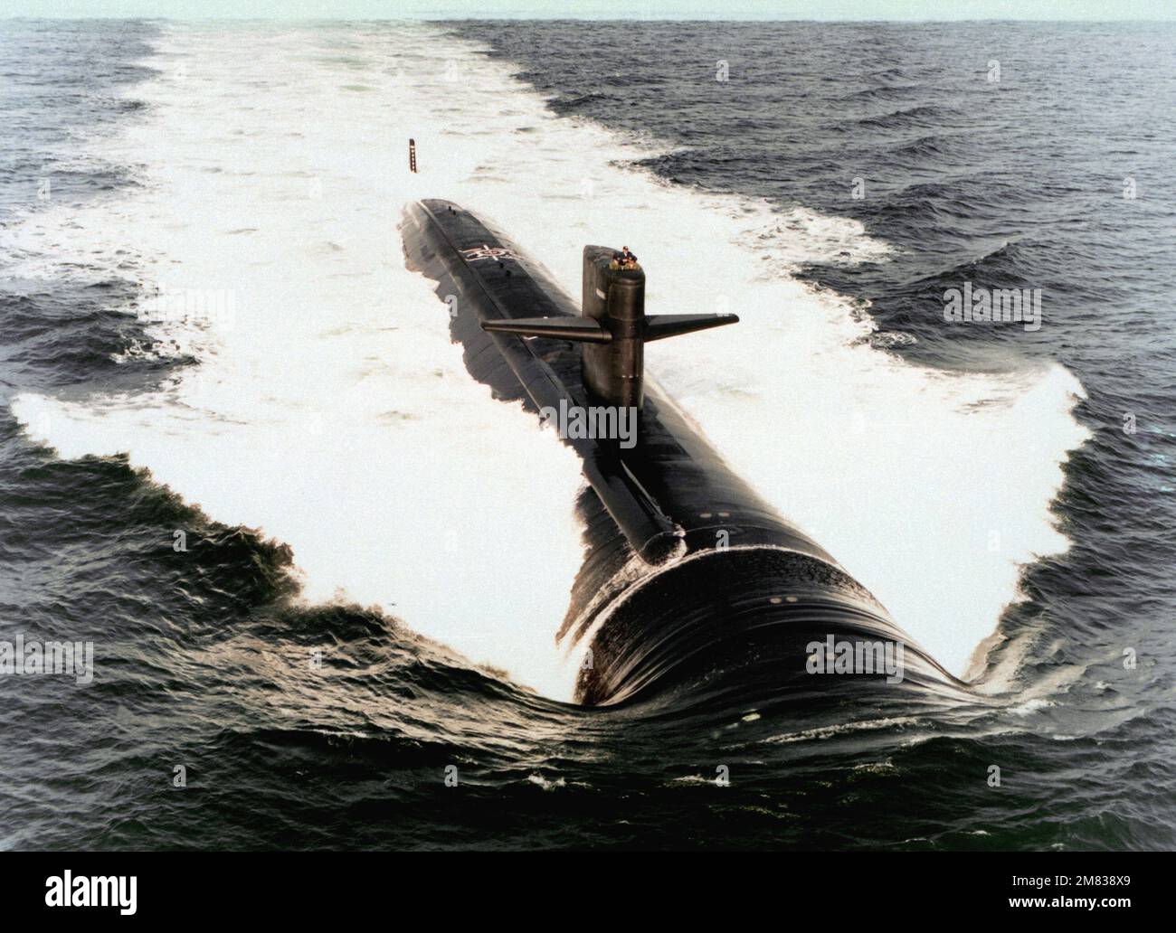 An aerial starboard bow view of the nuclear-powered attack submarine USS AUGUSTA (SSN-710) underway. Country: Unknown Stock Photo