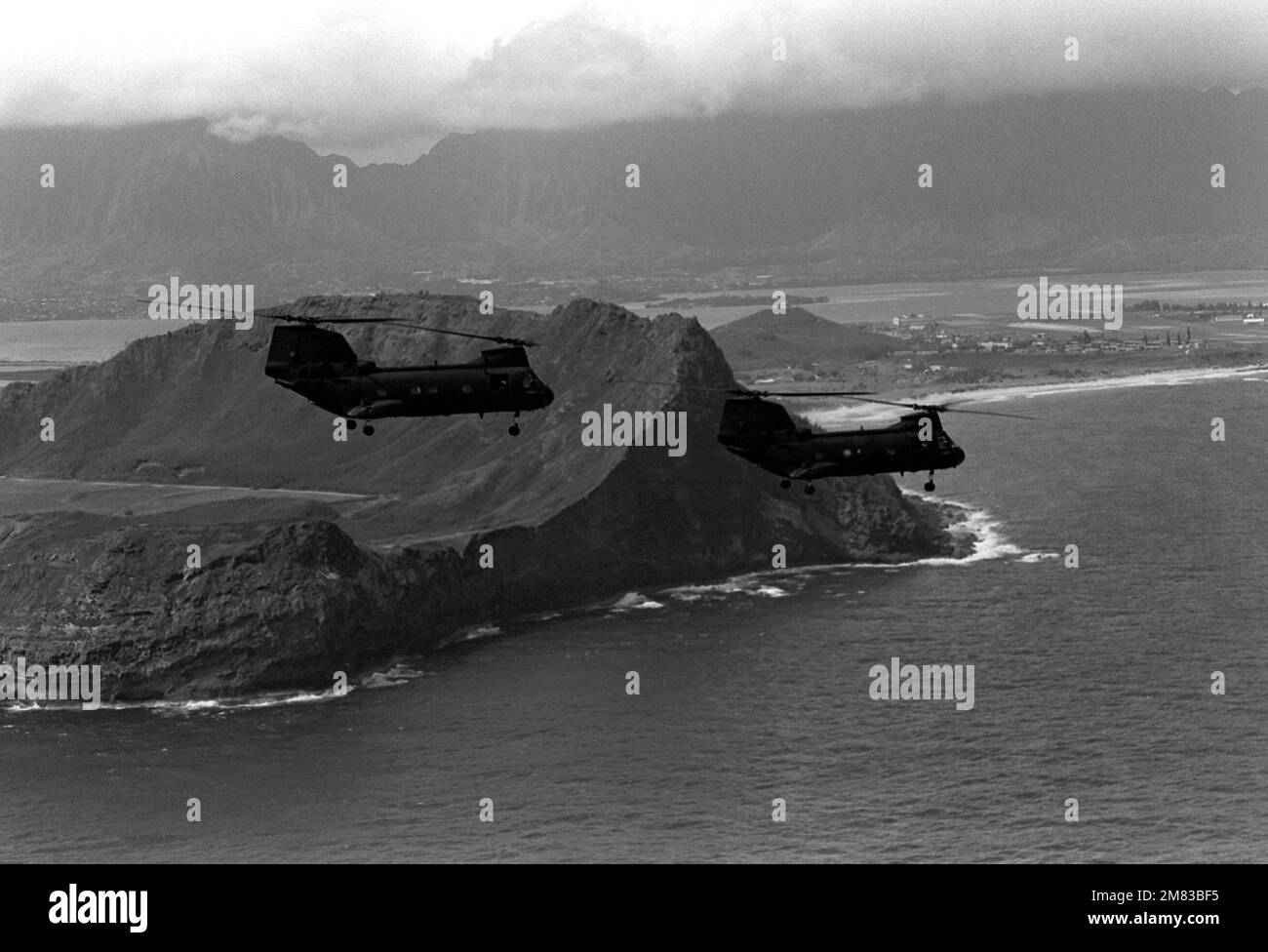 Two CH-46 Sea Knight helicopters from Marine Medium Helicopter Squadron 364 (HMM-364) fly past the air station. Base: Mcas, Kaneohe Bay State: Hawaii (HI) Country: United States Of America (USA) Stock Photo