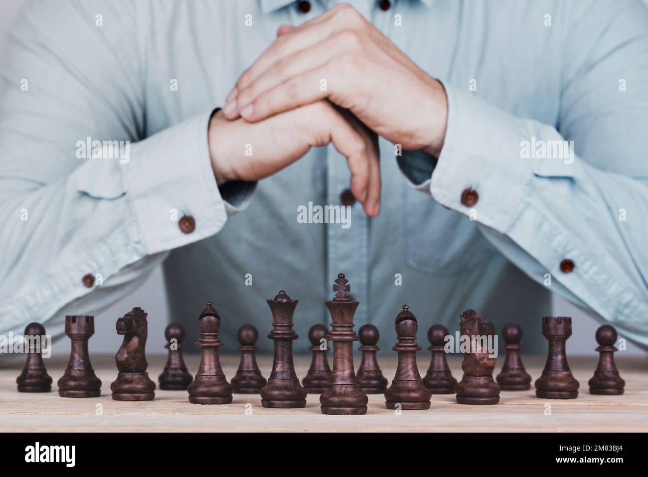 Businessman with clasped hands a brainstorming planning strategy in competition success play , concept strategy and successful management or leadershi Stock Photo
