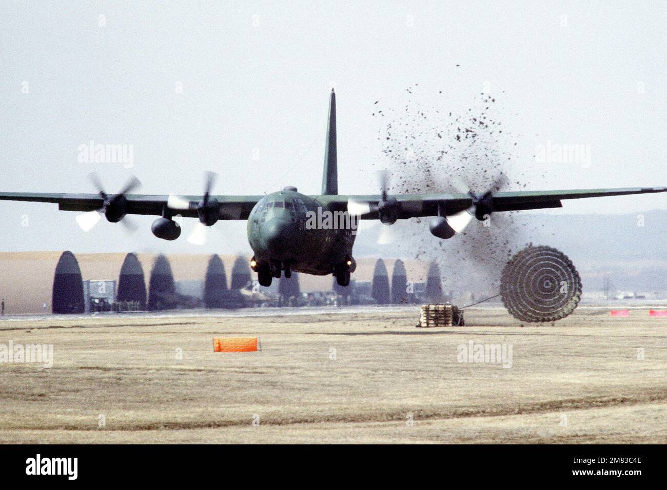 A C130E Hercules aircraft makes a low altitude parachute extraction