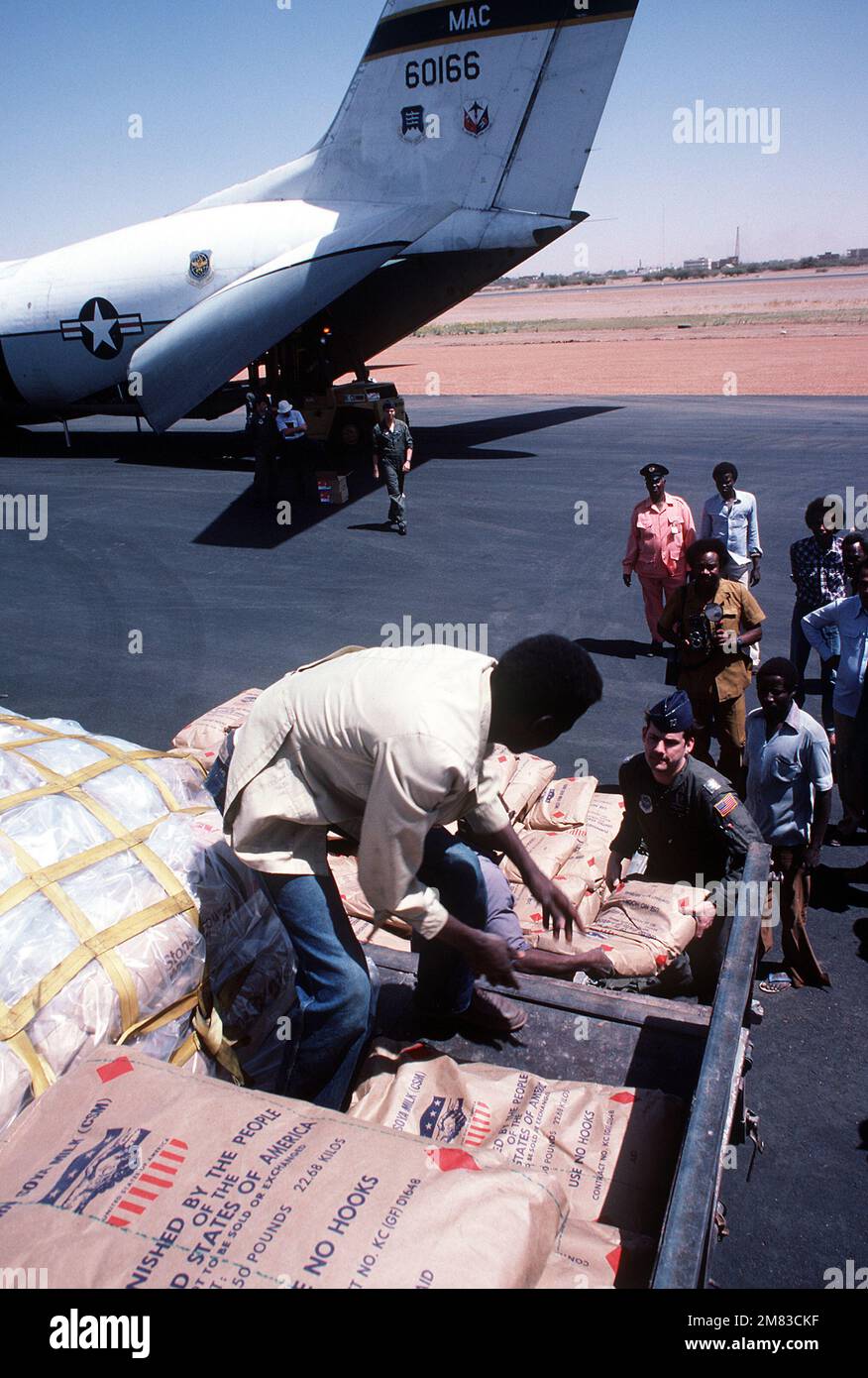 CAPT. Stephen Foote, airlift commander from the 6th Military Airlift Squadron, helps workers load a truck with food during the Ethiopian relief operations. Base: Khartoum Country: Sudan (SDN) Stock Photo