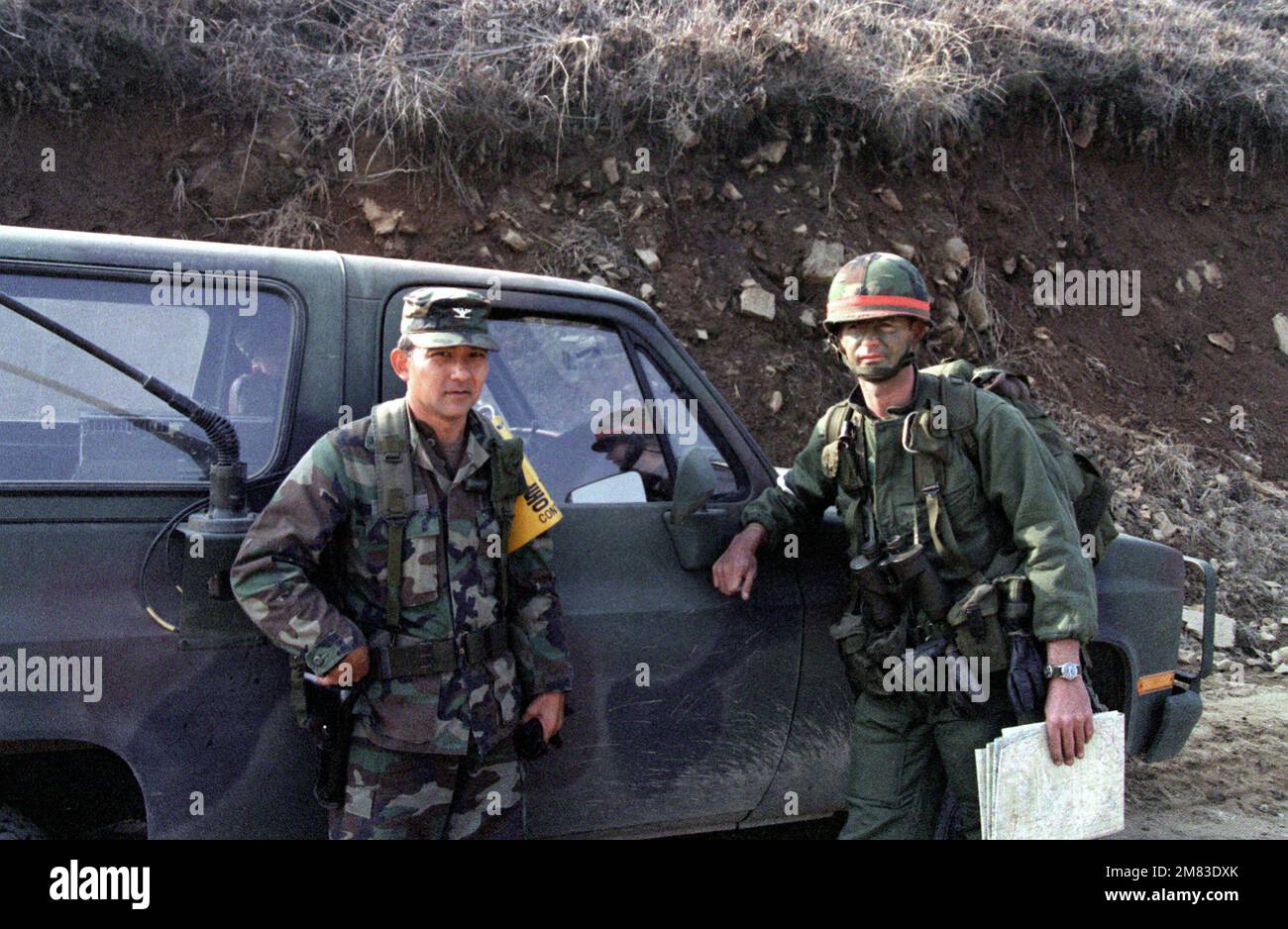 COL. Donald Oura, commander, 29th Brigade, Hawaii Army National Guard, speaks with LT. COL. George Close, commander, 1ST Bn., 5th Inf., 25th Inf. Div., during the joint U.S./Korea exercise Team Spirit '85. Oura is acting as the chief controller for the 1st Brigade, 25th Inf. Div., during the exercise. Subject Operation/Series: TEAM SPIRIT '85 Base: Geumsa Ri Country: South Korea Stock Photo