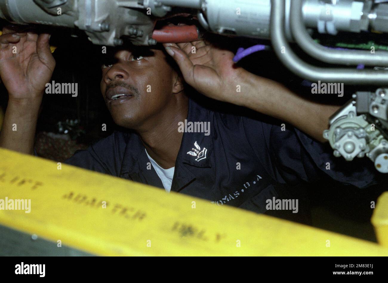 Aviation Machinist Mate Second Classs Thomas, removes a fuel flow ...