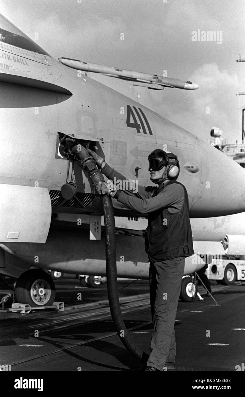 An F/A18 aircraft from StrikeFighter Squadron 25 (VFA25) is fueled on deck aboard the