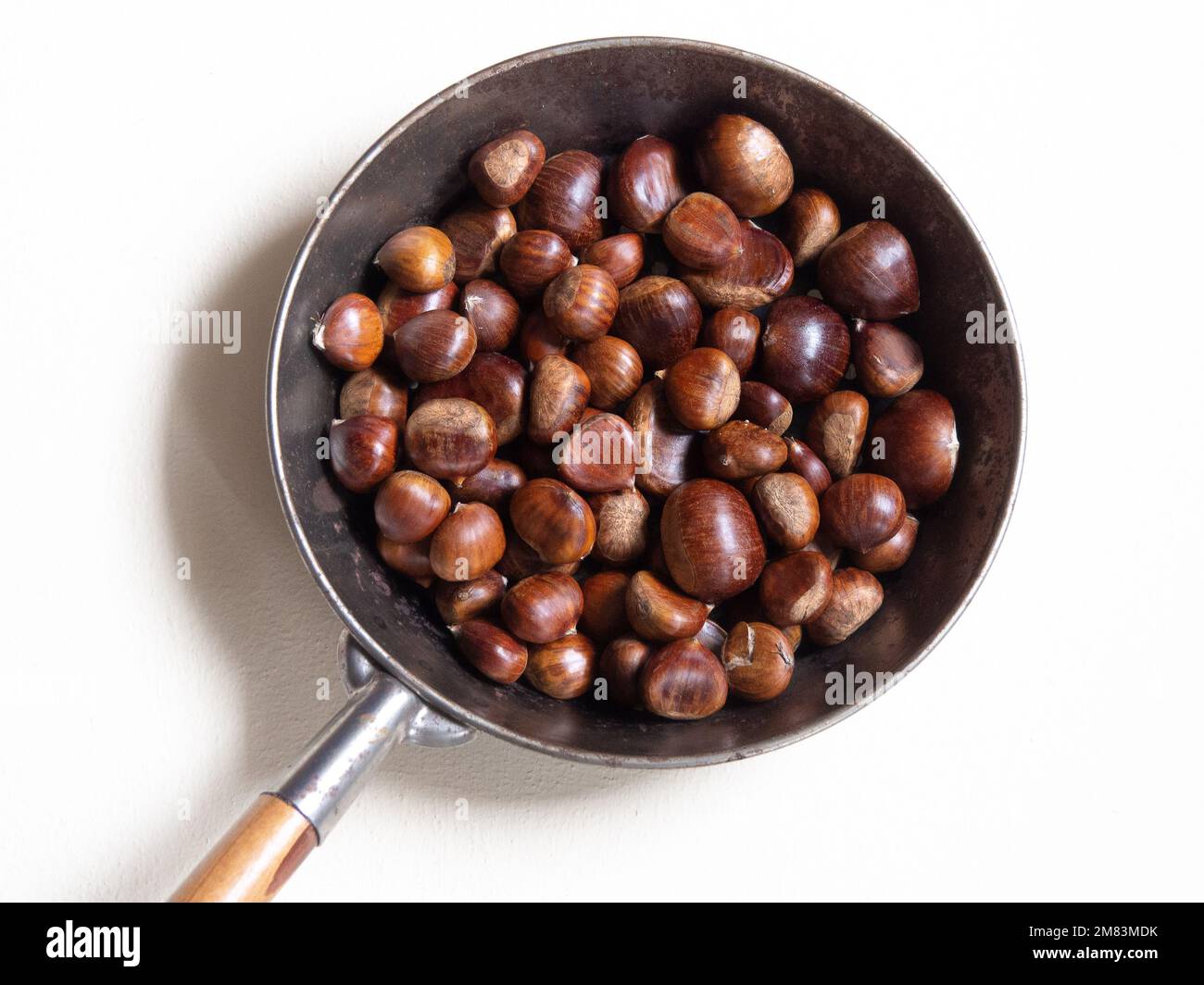 Picture taken from above with lots of sweet chestnuts in a roasting pan