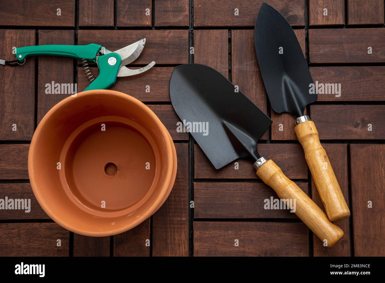 Gardening tools top view on wooden deck background with copy space