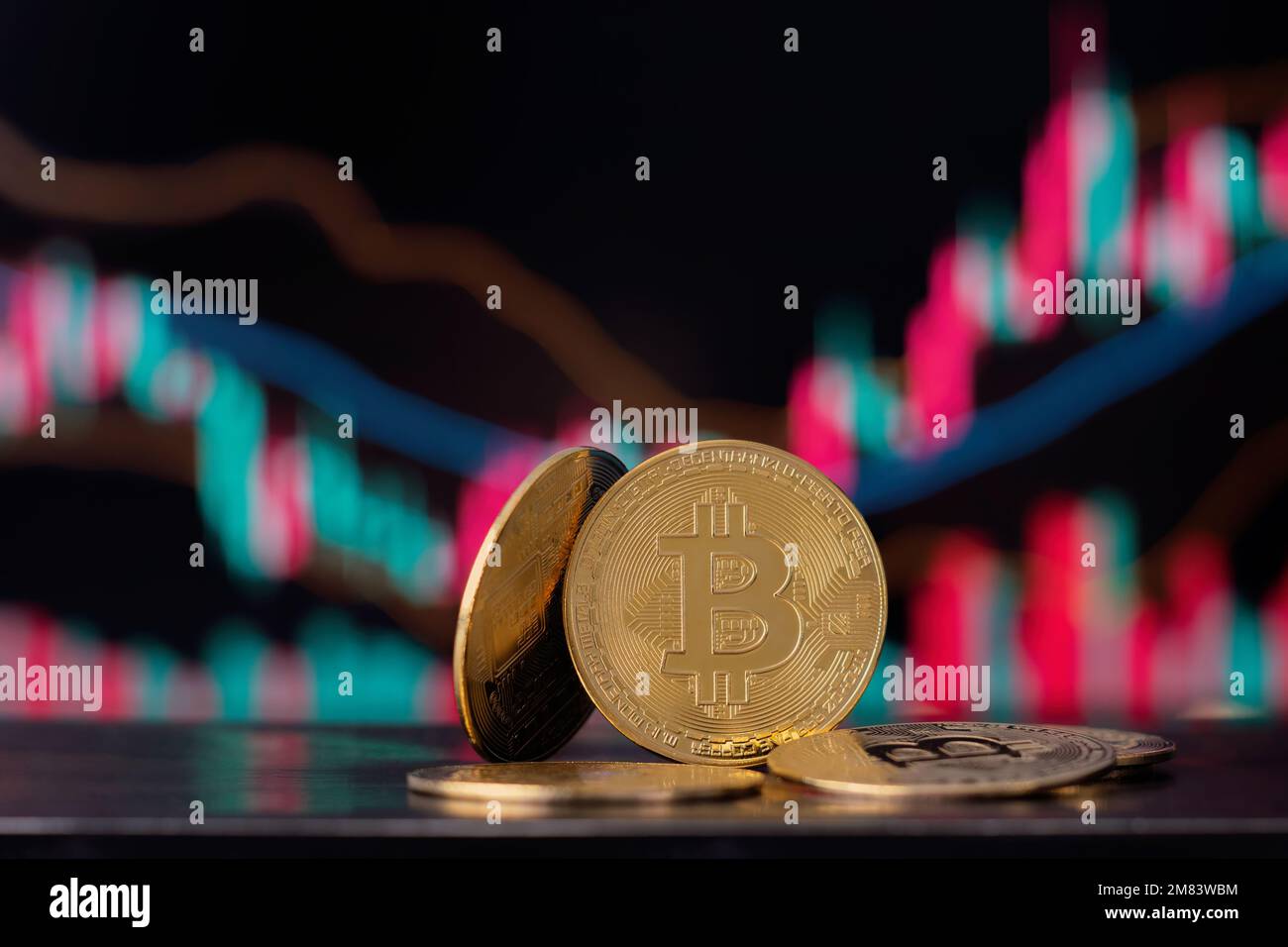 Bitcoin cryptocurrency coins on graphic diagram background. Stock Photo