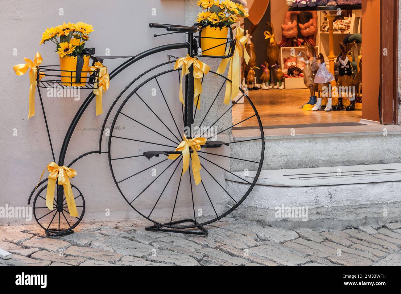 A large antique bicycle as a decoration in front of one of the souvenir