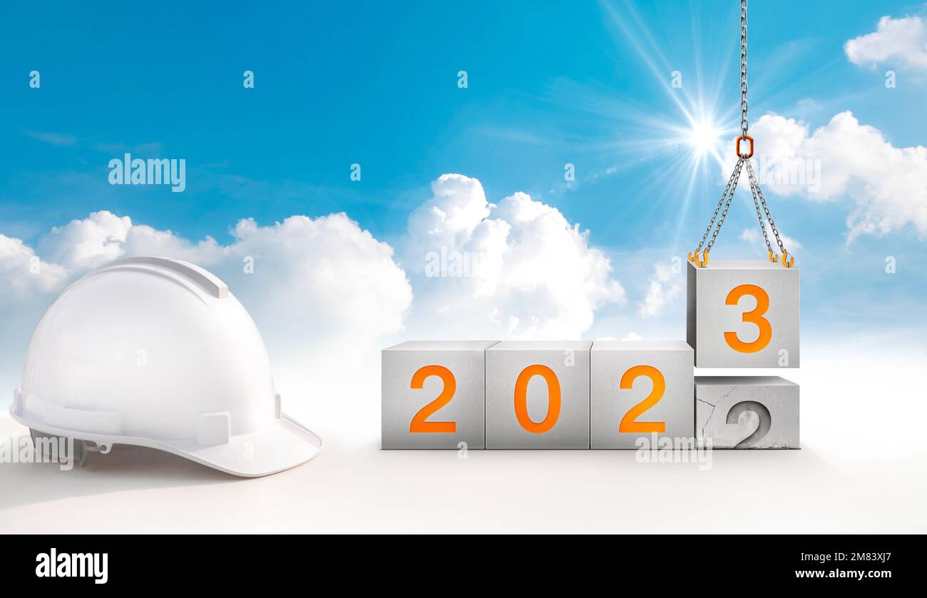 construction start working in the new year 2023. Success real estate, teamwork, and a healthy environment.Construction-crane lifting the cube and numb Stock Photo