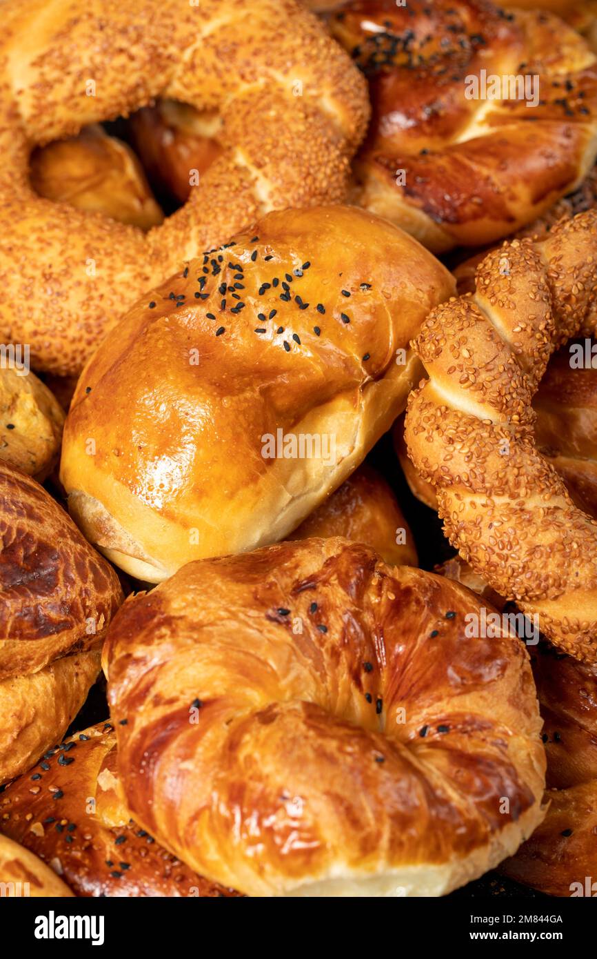 Bagel and pogaca varieties. They eat pastries in piles. Bakery products