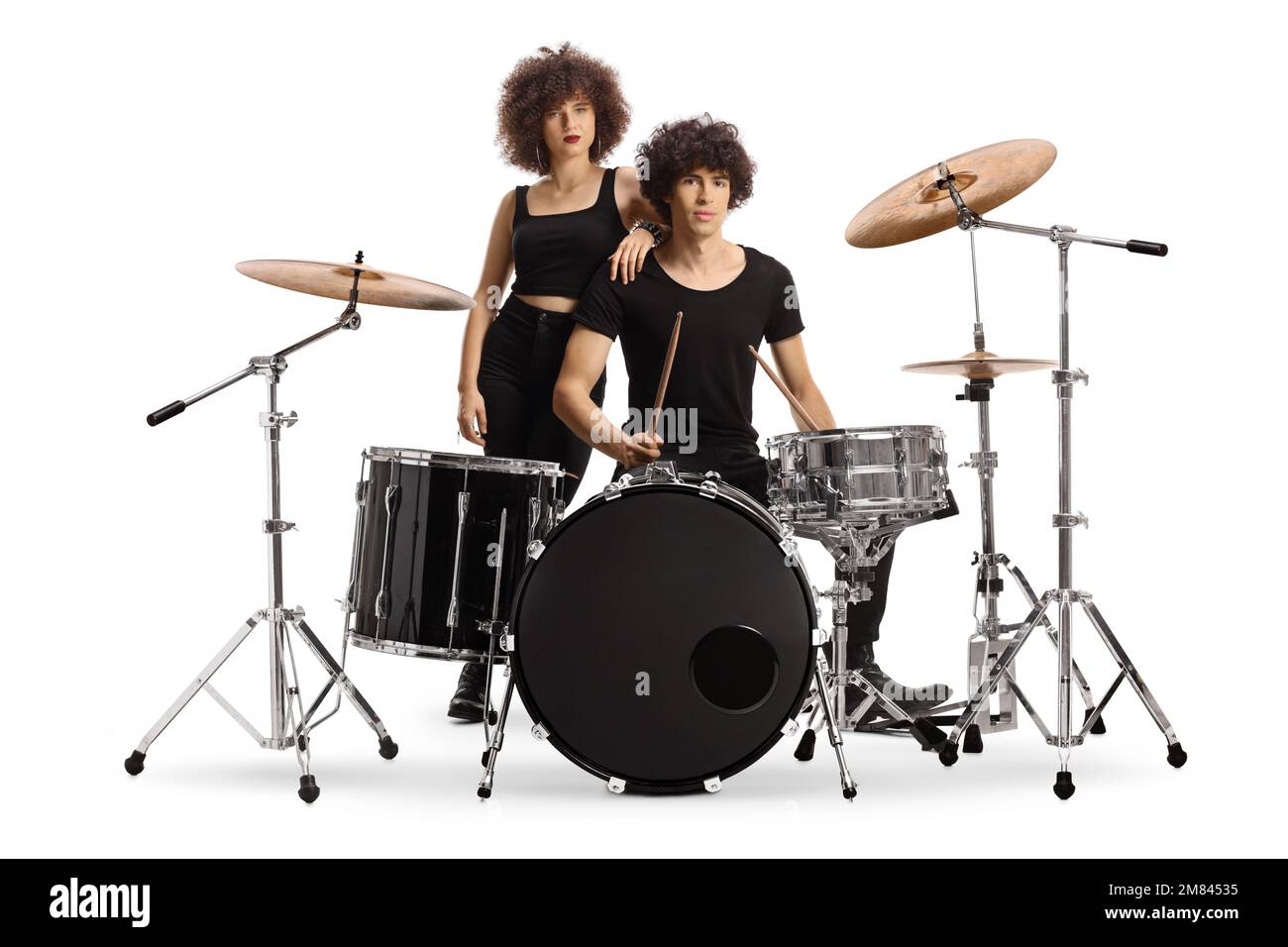 Male and female drummers posing with a drum kit isolated on white background Stock Photo