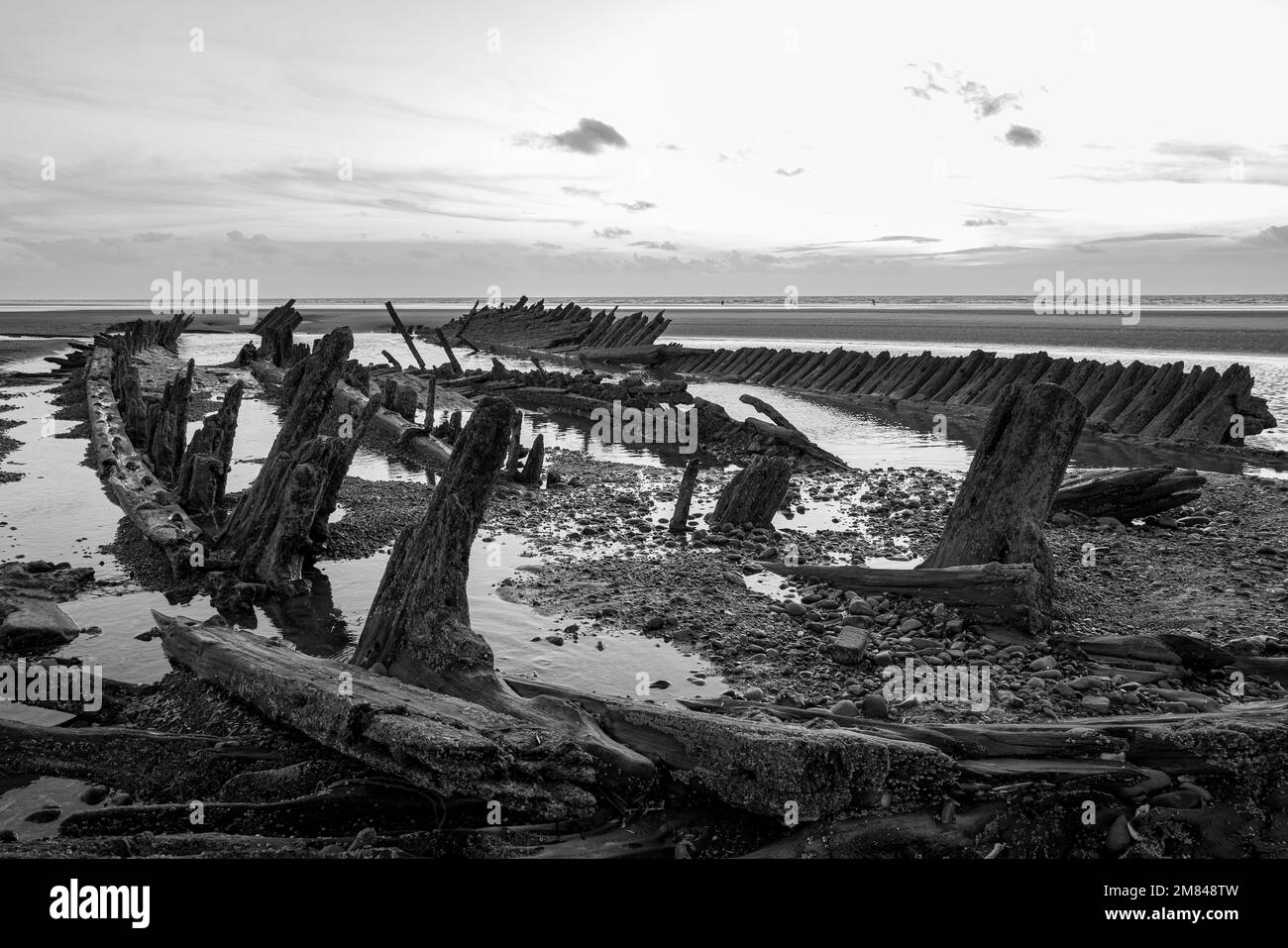 The sun sets near the remains of the shipwrecked Abana - which ran aground at Anchorsholme, near Cleveleys, Lancashire, in 1894 - in October 2022. Stock Photo