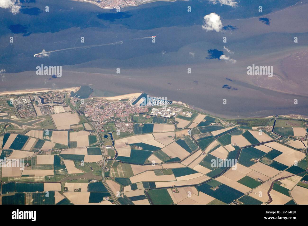 View from the air looking North towards the harbour town of Breskens on the Westerschelde coastline of the Netherlands on a sunny Spring afternoon.  T Stock Photo