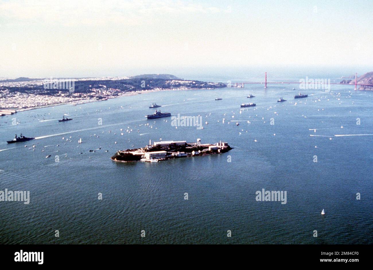 Aerial view of US Navy ships including the amphibious assault ship USS PELELIU (LHA 5), and an aircraft carrier entering the bay during San Francisco's Fleetweek celebration. Base: San Francisco State: California (CA) Country: United States Of America (USA) Stock Photo