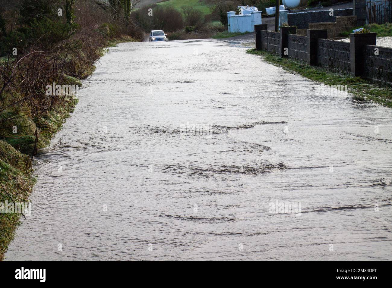 Road covered in winter flood waters Stock Photo