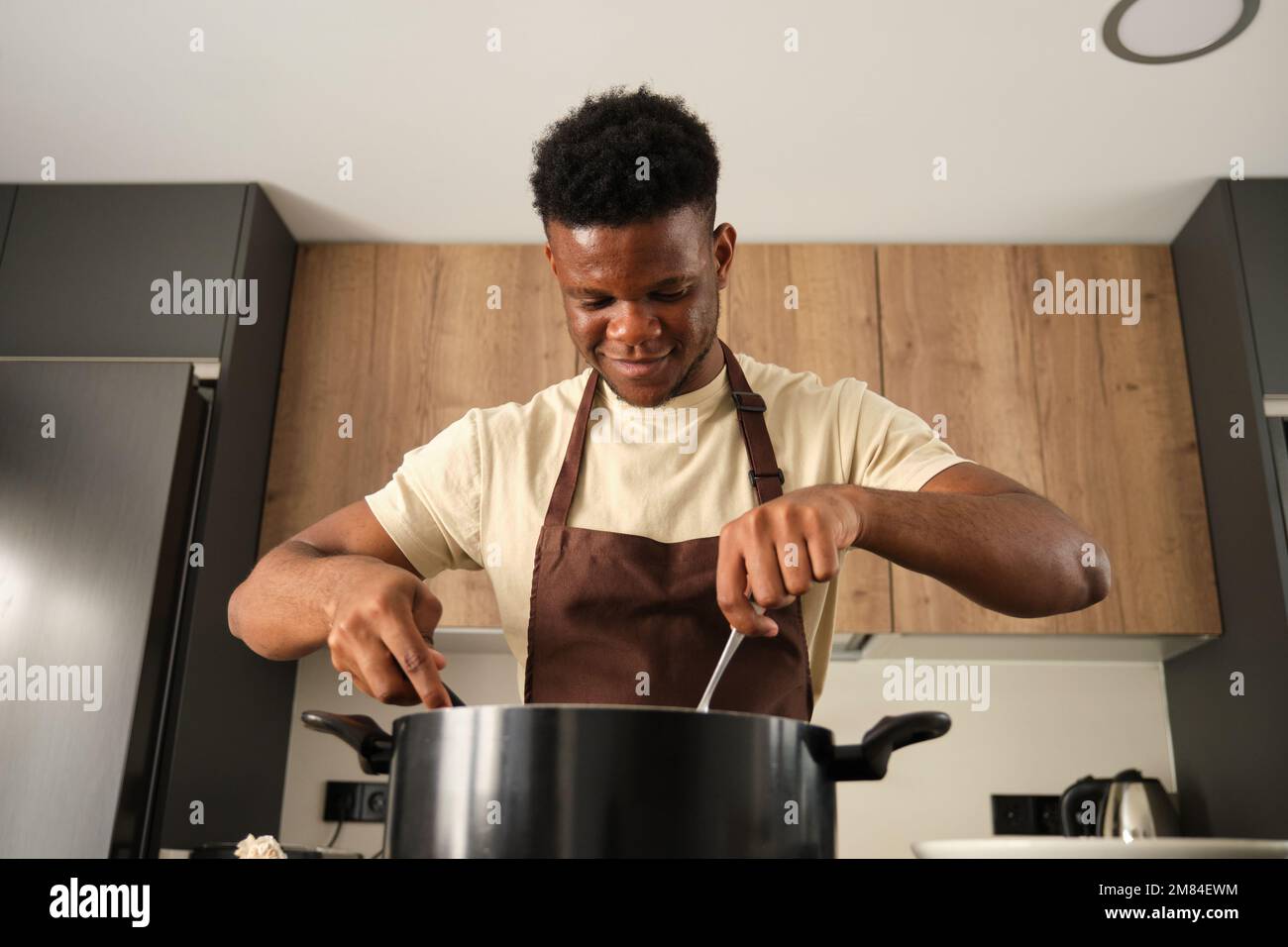 Cook with big cooking pot in the kitchen, Stock Photo, Picture And
