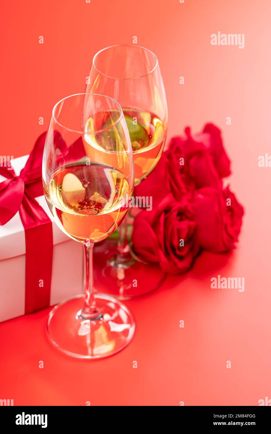 Valentines day card with champagne, rose flowers and gift box. On red ...