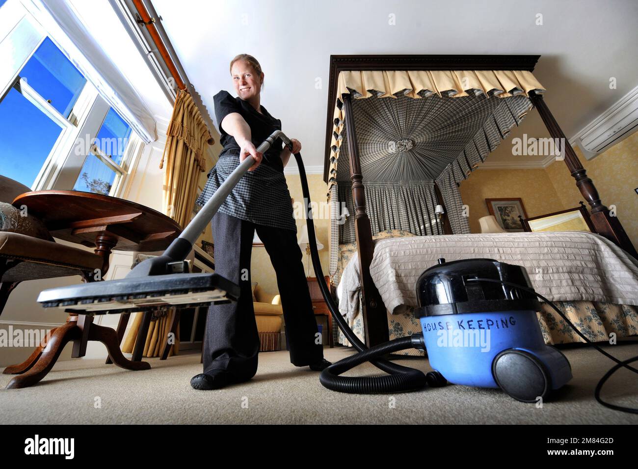 A Housekeeper preparing a hotel room. Stock Photo