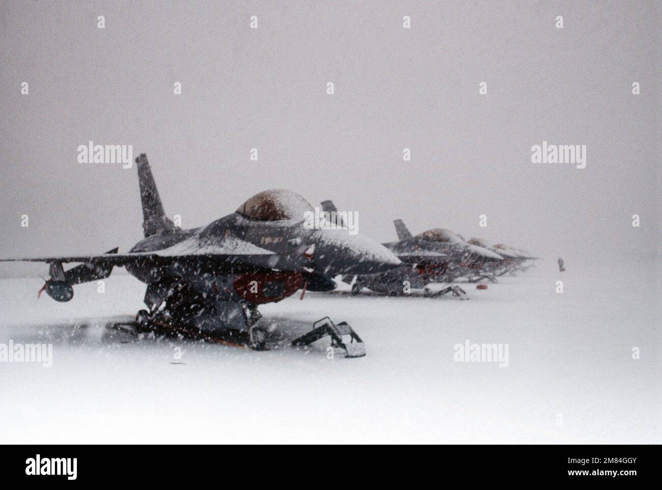 Snow falls on F-16A Fighting Falcon aircraft of the 13th Tactical Fighter Squadorn sitting on the flight line. The 13th is part of the 432nd Tactical Fighter Wing that was activated in 1984. Base: Naval Air Facility, Misawa State: Aomori Country: Japan (JPN) Stock Photo