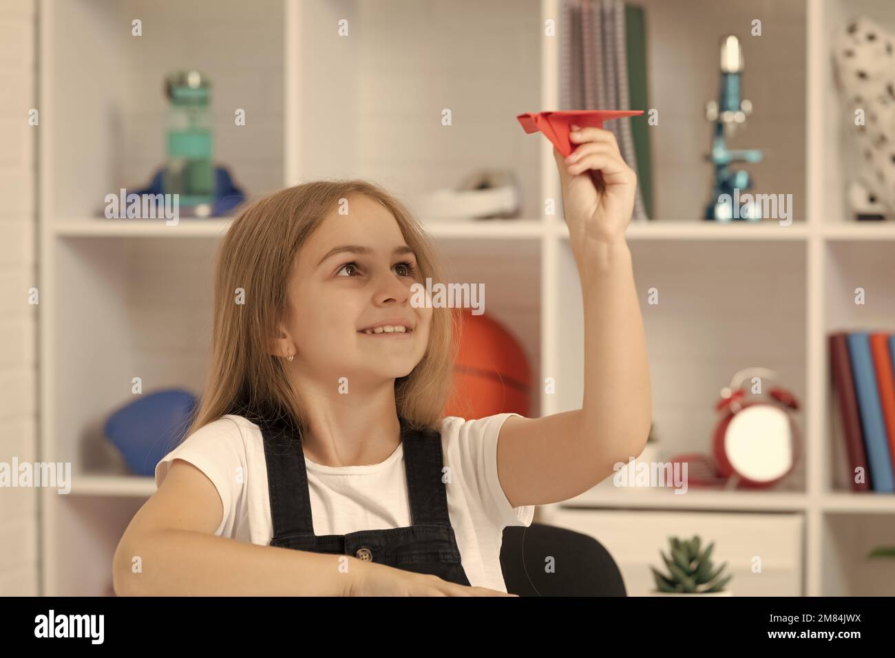 Playing With Paper happy kid play with paper plane in school classroom Stock Photo - Alamy