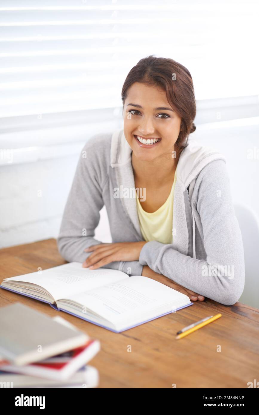 Hitting the books diligently. Portrait of a pretty young university