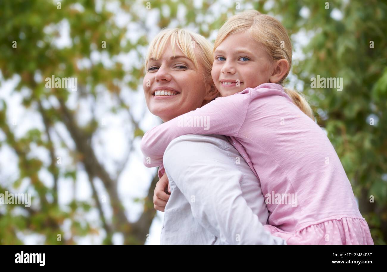Feeling safe with my mom. A beautiful young mother smiling as she gives