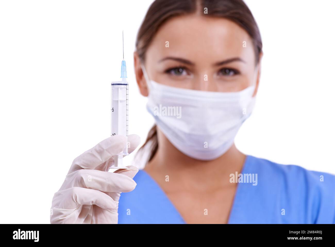 Ready to go to sleep...A young doctor wearing a surgical mask holding a syringe Stock Photo Alamy