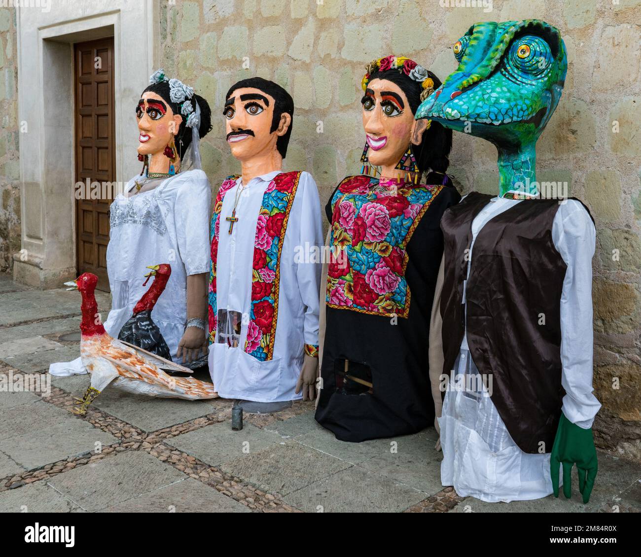 Giant puppets in traditional dress called monos de calenda before a Giant puppets in traditional dress called monos de calenda before a