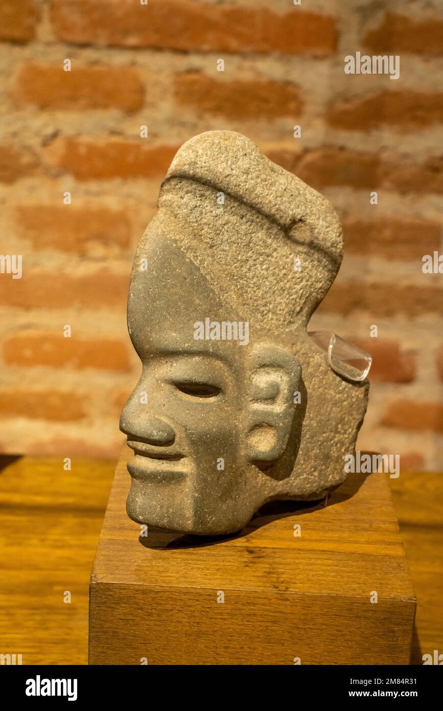 Ceremonial carved stone axe head in the shape of a man from the pre