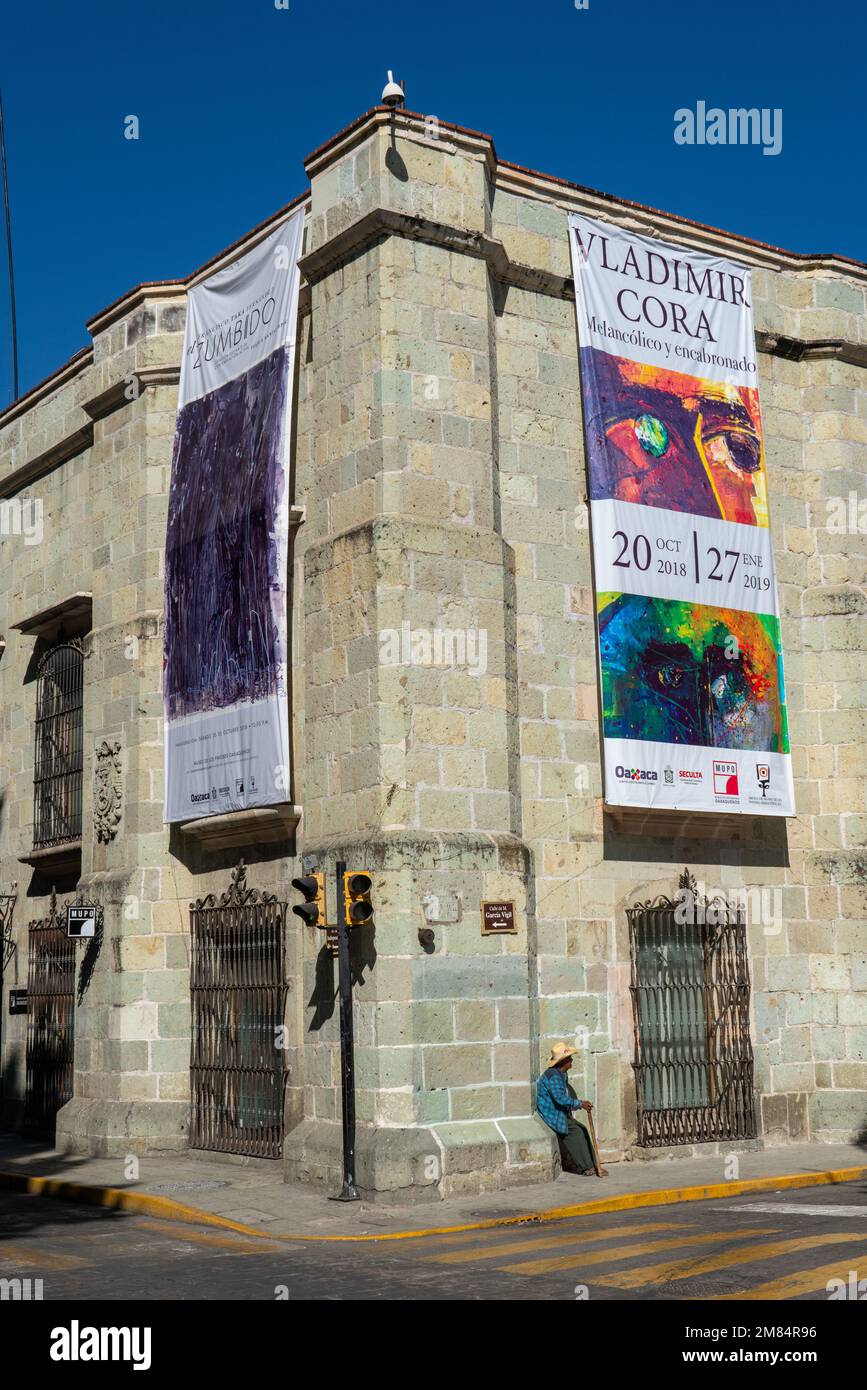 Banners advertising an exhibit in the Museum of Oaxacan Painters or Museo de los Pintores Oxaquenos, Oaxaca, Mexico.  The historic buidling was origin Stock Photo