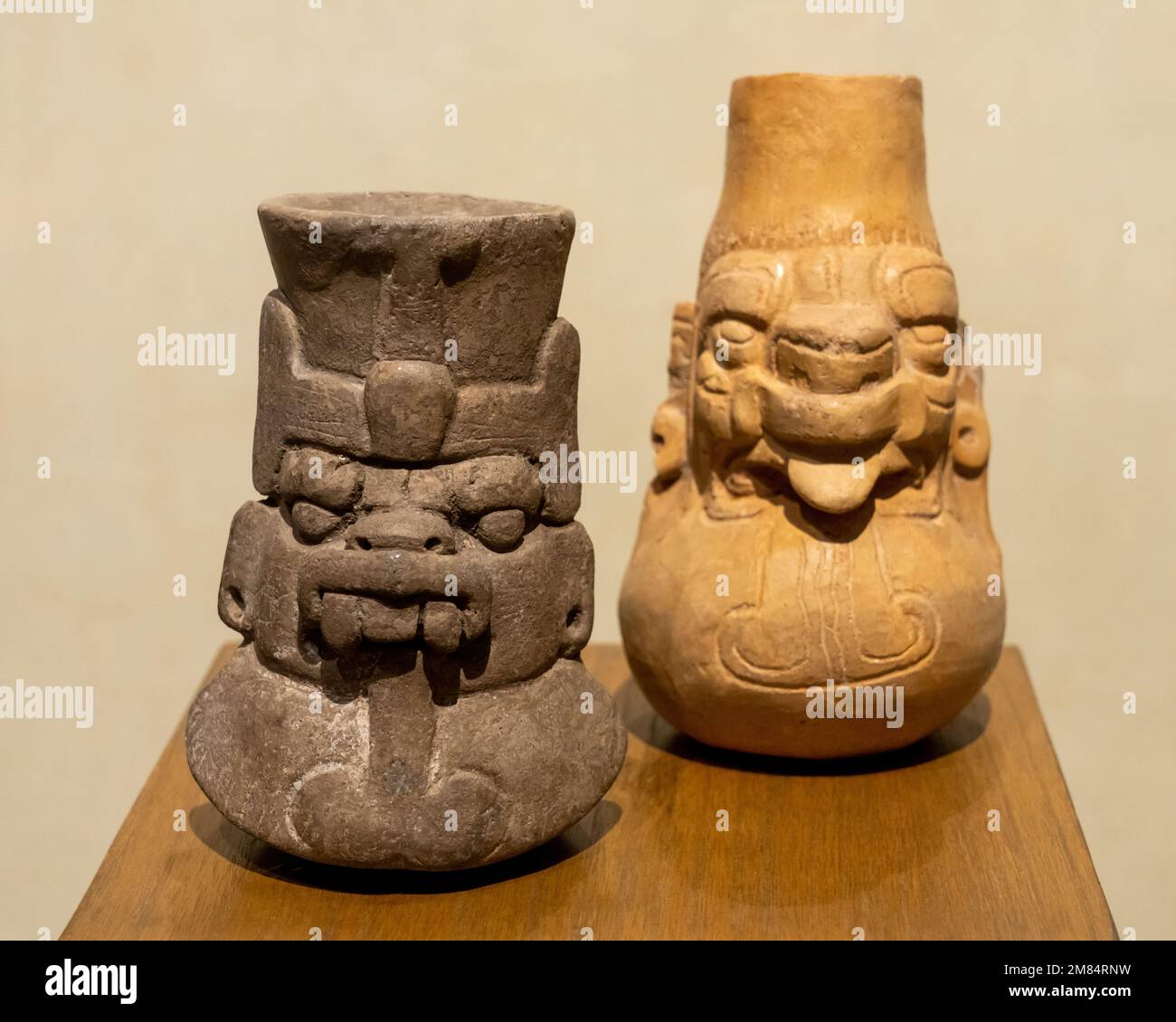 Two pre-Hispanic ceramic Zapotec funerary urns of Cocijo, the god of rain, in the Museum of Oaxacan Culture, Oaxaca, Mexico. Stock Photo