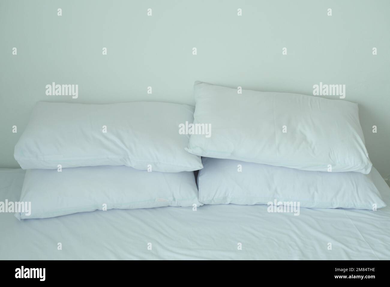 white pillow lined up on bed  Stock Photo