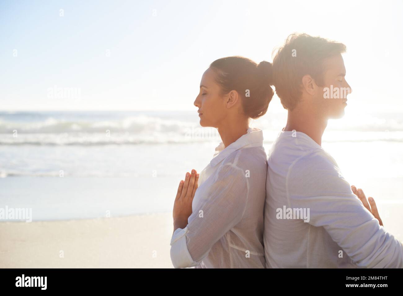 Finding peace and tranquility. A young couple performing a relaxing