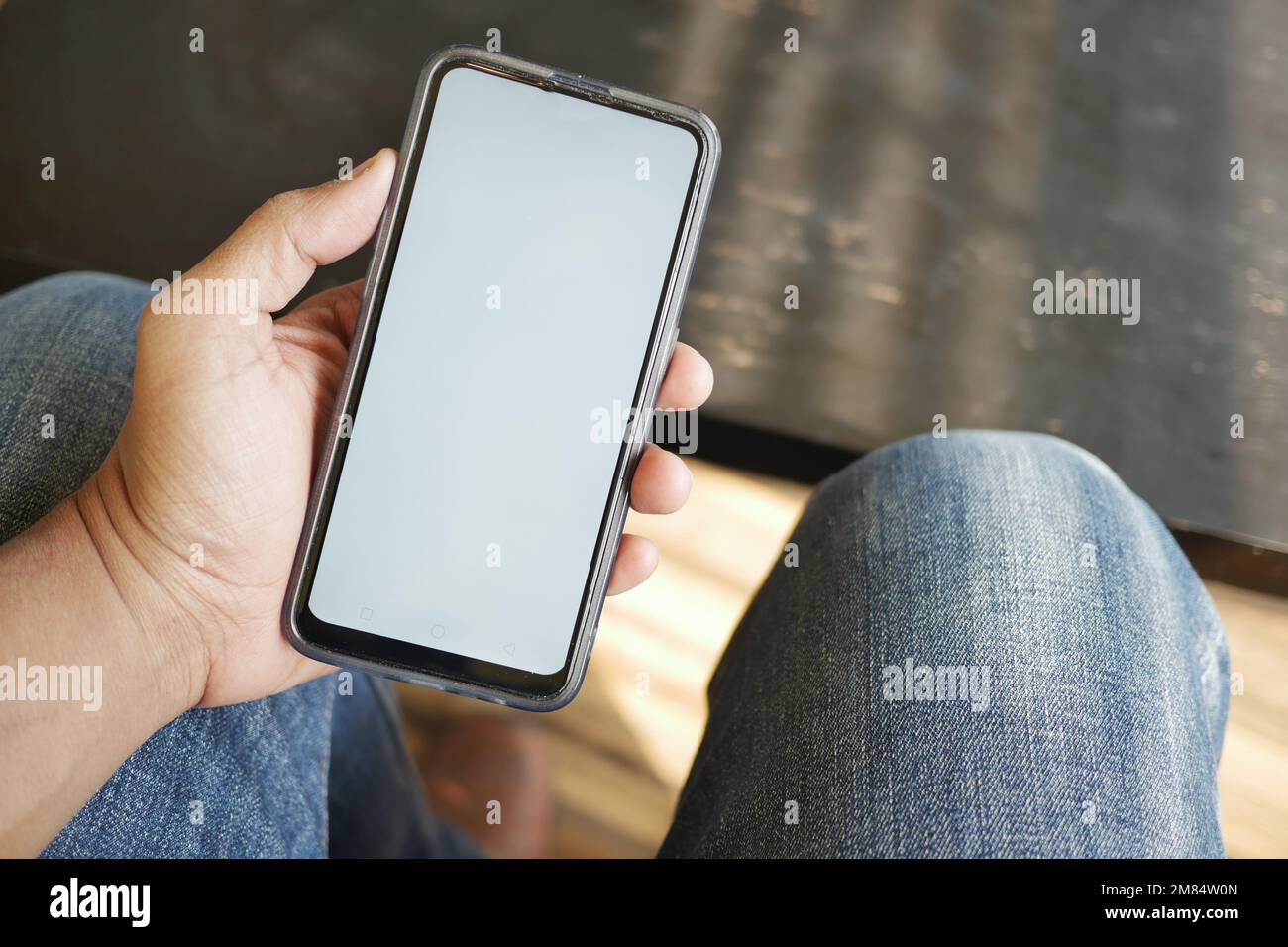 young man hand using smart phone with green screen at cafe Stock Photo ...