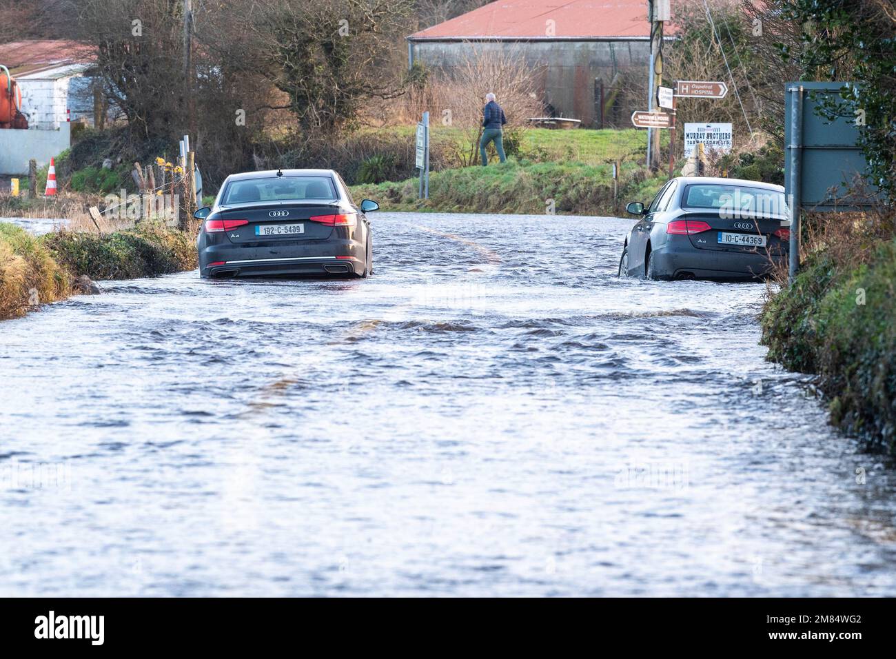 Dunmanway, West Cork, Ireland. 12th Jan, 2023. The R587 Dunmanway to Macroom road flooded this morning after a night of torrential rain amidst a Met Éireann Yellow Weather Warning. Two cars were seen to be abandoned in the flood but despite this, vehicles still drove through the flood waters. Picture: Andy Gibson. Credit: AG News/Alamy Live News Stock Photo