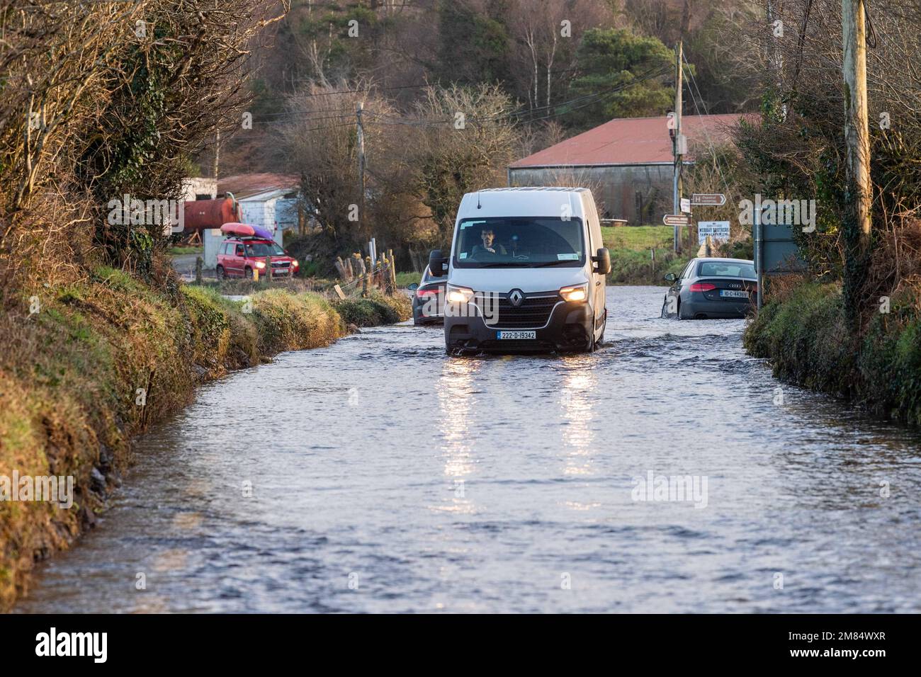 Dunmanway, West Cork, Ireland. 12th Jan, 2023. The R587 Dunmanway to Macroom road flooded this morning after a night of torrential rain amidst a Met Éireann Yellow Weather Warning. Two cars were seen to be abandoned in the flood but despite this, vehicles still drove through the flood waters. Picture: Andy Gibson. Credit: AG News/Alamy Live News Stock Photo