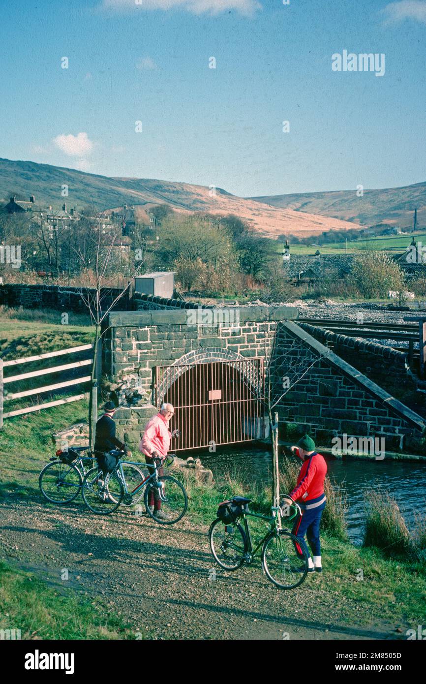 Group of elderly men with bicycles beside entrance to Standedge canal tunnel in 1982, Diggle, Greater Manchester Stock Photo