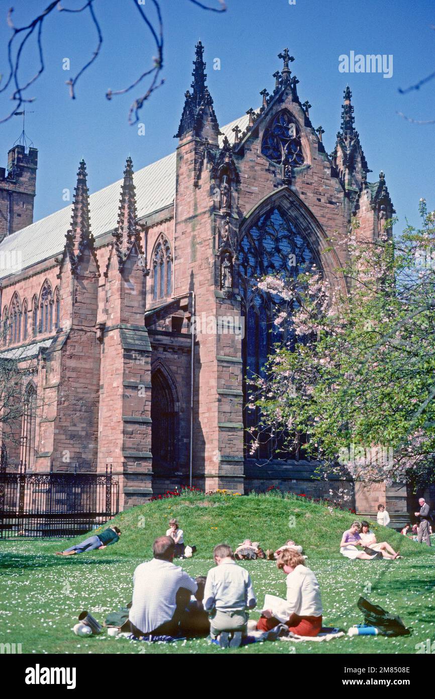 People enjoying the sunshine in the grounds of the Cathedral in 1984, Carlisle, Cumbria Stock Photo