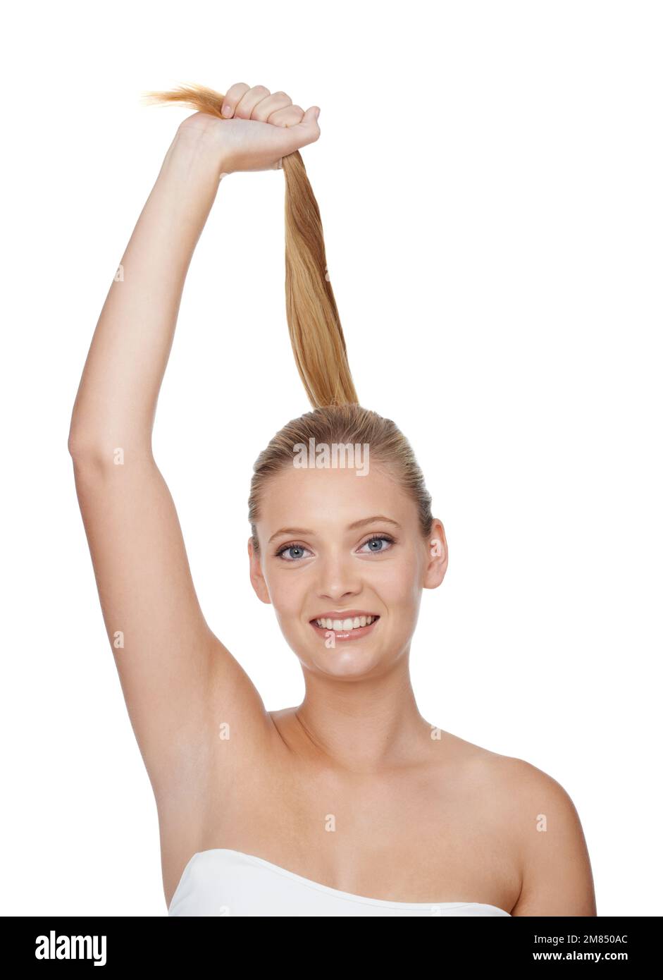 Strong and healthy hair. A young blonde woman smiling at the camera while isolated on white. Stock Photo