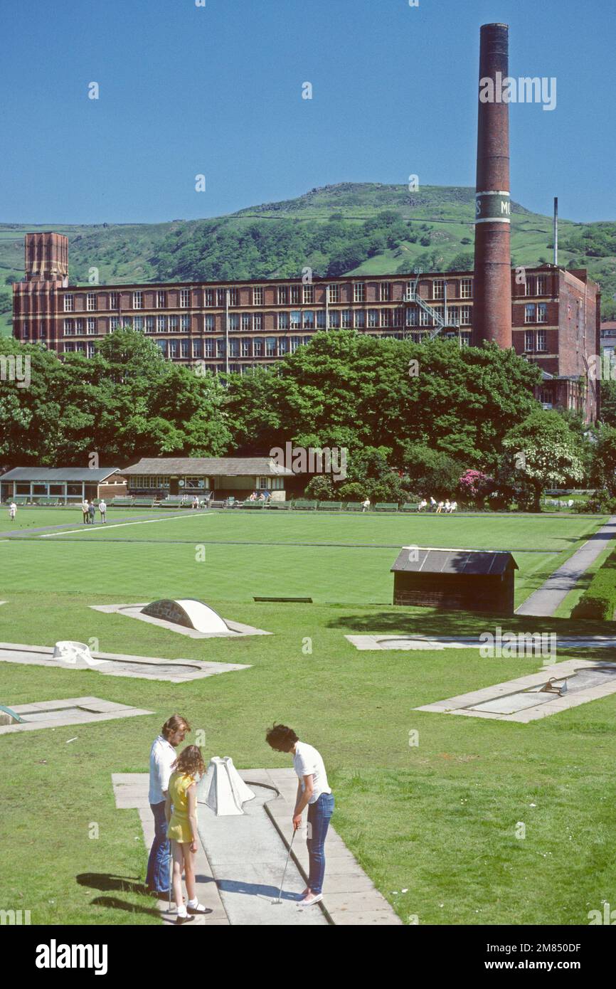 Family playing crazy golf in Centre Vale Park in 1986 with mill in background, Todmorden, West Yorkshire, UK Stock Photo