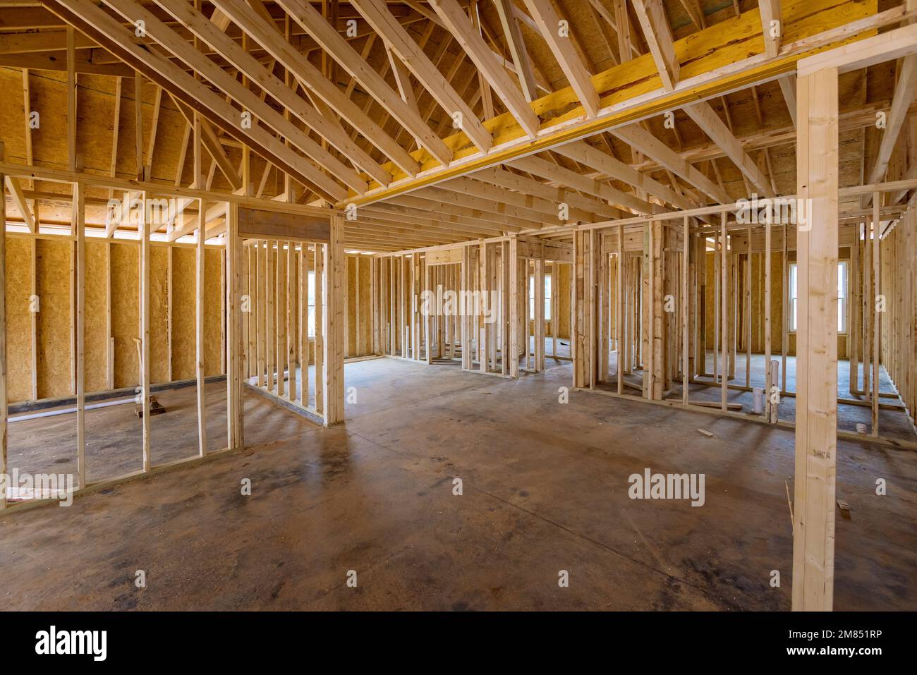 This an interior framing newly constructed house under construction, which is framed with truss beams Stock Photo