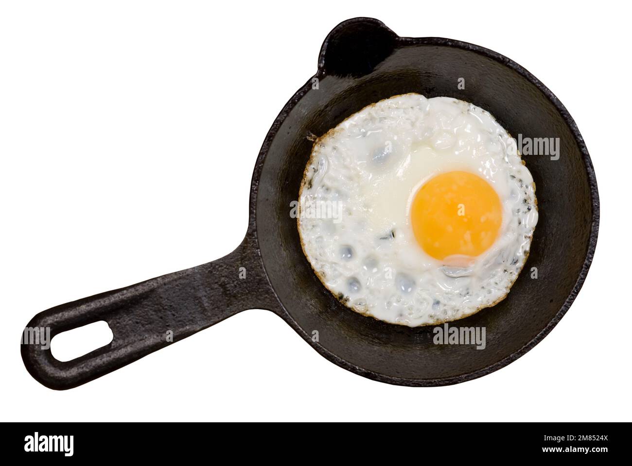 Fried egg on cast iron skillet on white Stock Photo