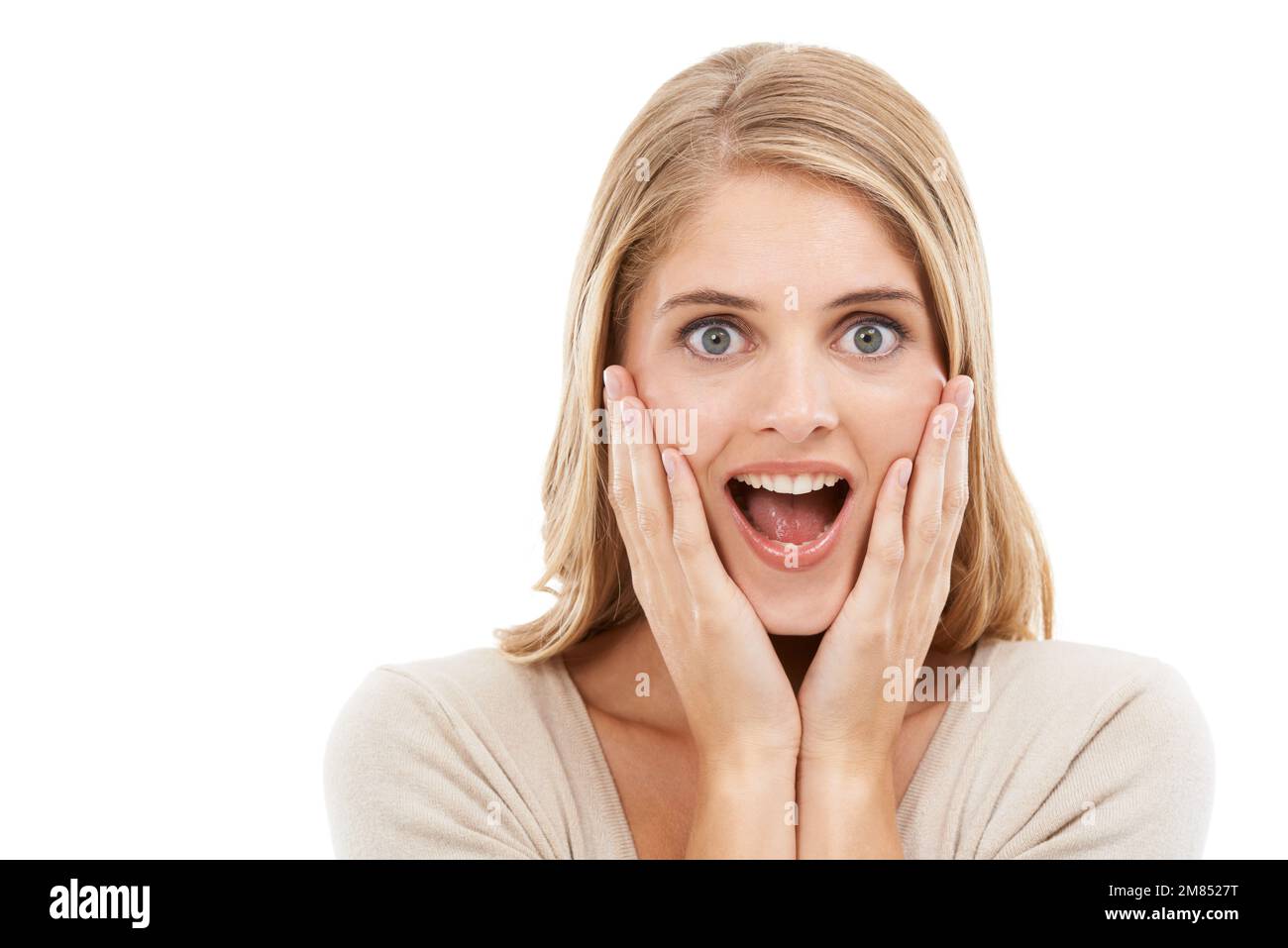 Im truly at a loss for words. Studio portrait of a surprised-looking blonde woman isolated on white. Stock Photo